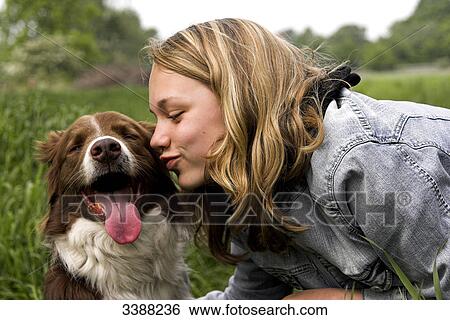 Stock Photograph - Teenage girl kissing Border Collie . Fotosearch