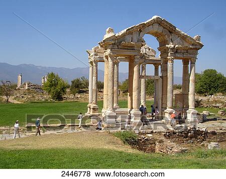 Stock Photo - Tourists at archaeological site, Tetrapylon, Aphrodisias, Caria, Turkey . Fotosearch