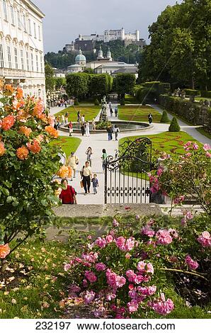 Tourists at garden with castle in background, Mirabell Garden, Hohensalzburg Castle, Salzburg, Austria View Large Photo Image Stock Photo - Tourists at garden with castle in background, Mirabell Garden, Hohensalzburg Castle, Salzburg, Austria . Fotosearch