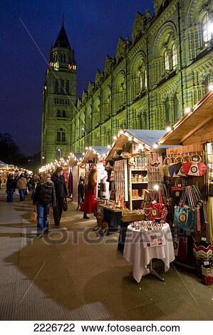 Stock Image - Tourists at market in front of museum, Natural History Museum, City Of London, Greater London, England . Fotosearch