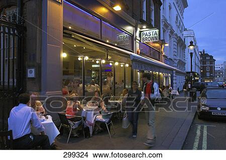 Tourists at sidewalk cafe during night, London, England View Large Photo Image Picture - Tourists at sidewalk cafe during night, London, England . Fotosearch