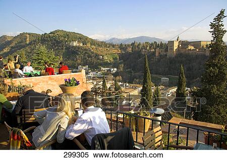 Stock Photography - Tourists sitting in balcony, Granada, Andalusia, Spain . Fotosearch