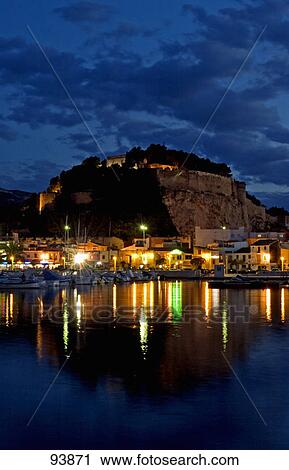 Stock Image - Town at waterfront lit up at night, Denia (Costa Blanca), Alicante, Spain . Fotosearch