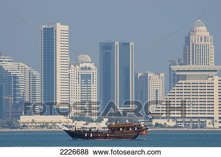 Traditional boats Dhow in sea with skyscraper in background, Doha, Qatar View Large Photo Image Stock Photo - Traditional boats Dhow in sea with skyscraper in background, Doha, Qatar . Fotosearch