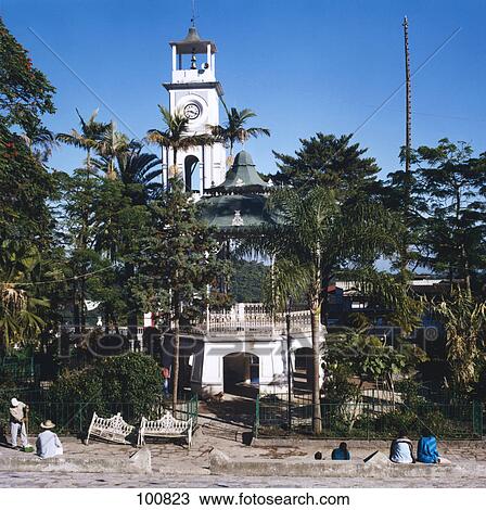 Stock Image - Trees in front of bell tower of church, Zocalo, Cuetzalan, Mexico . Fotosearch