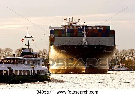 Tugboats pulling a cargo ship, Hamburg, Germany View Large Photo Image Stock Image - Tugboats pulling a cargo ship, Hamburg, Germany . Fotosearch