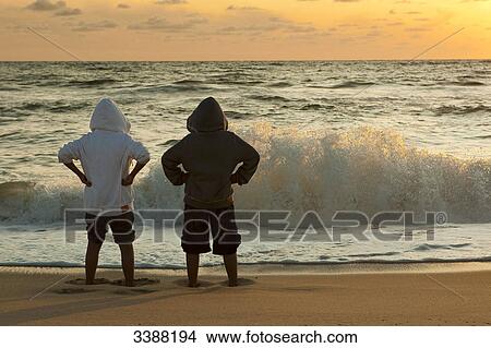 Two boys on the beach, Rantum, Sylt, Germany, rear view View Large Photo Image Picture - Two boys on the beach, Rantum, Sylt, Germany, rear view . Fotosearch