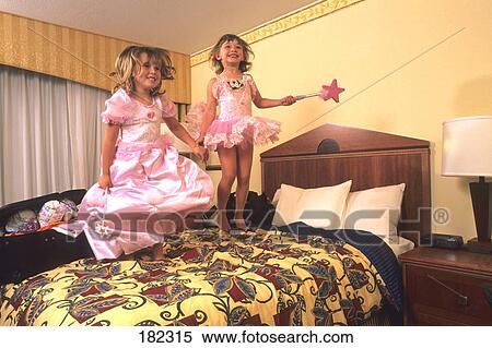 Two girls jumping on bed View Large Photo Image Stock Photography - Two girls jumping on bed . Fotosearch
