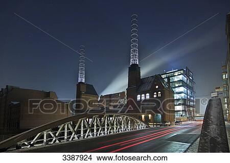 View of the illuminated boiler house in the old warehouse district (Speicherstadt), Hamburg, Germany, long exposure View Large Photo Image Picture - View of the illuminated boiler house in the old warehouse district (Speicherstadt), Hamburg, Germany, long exposure . Fotosearch