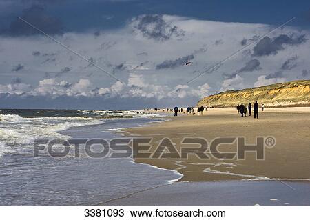 Stock Image - Walker at beach, Sylt, Schleswig-Holstein, Germany . Fotosearch