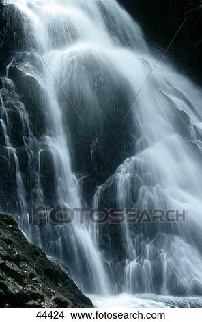 Picture - Water falling over rocks . Fotosearch