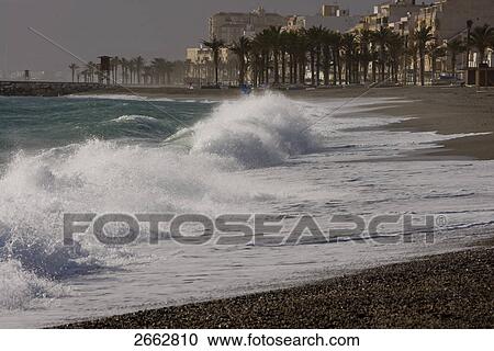 Stock Image - Waves on beach, Costa del Sol, Granada, Andalusia, Spain . Fotosearch