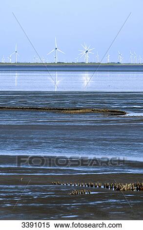 Stock Photography - Windmills at mudflat, Schleswig-Holstein, Germany . Fotosearch