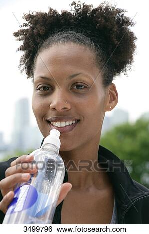 Stock Photograph - Woman holding a water bottle, portrait . Fotosearch