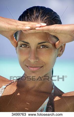 Woman holding hands on forehead, portrait View Large Photo Image Stock Image - Woman holding hands on forehead, portrait . Fotosearch