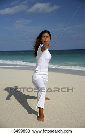 Woman practising yoga on a beach, Paradise Island, Bahamas View Large Photo Image Stock Image - Woman practising yoga on a beach, Paradise Island, Bahamas . Fotosearch