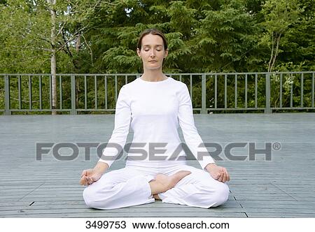 Woman sitting in lotus position on a deck, front view View Large Photo Image Stock Image - Woman sitting in lotus position on a deck, front view . Fotosearch