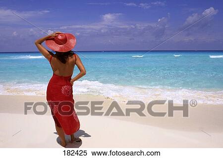 Woman standing on beach View Large Photo Image Stock Photography - Woman standing on beach . Fotosearch