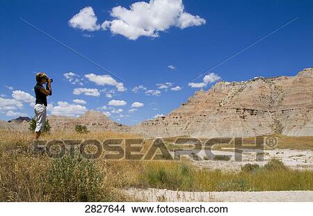 Picture - Woman taking pictures with her camera, South Dakota, USA . Fotosearch