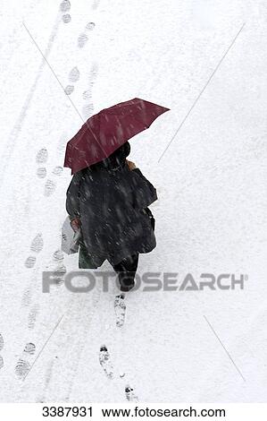 Woman with umbrella and shopping bags walking through snow, bird's eye view View Large Photo Image Stock Image - Woman with umbrella and shopping bags walking through snow, bird's eye view . Fotosearch