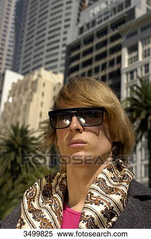 Stock Photography - Young man wearing scarf and sunglasses, Sydney, Australia, portrait . Fotosearch