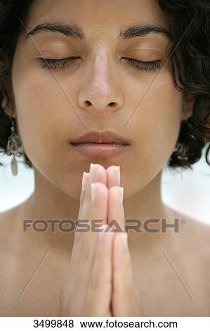 Young woman folding hands, portrait View Large Photo Image Stock Photo - Young woman folding hands, portrait . Fotosearch