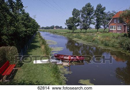 Boat moored in canal, Wynhamster Kolk, Dollart, East Frisia, Lower Saxony, Germany View Large Photo Image Picture - Boat moored in canal, Wynhamster Kolk, Dollart, East Frisia, Lower Saxony, Germany . Fotosearch