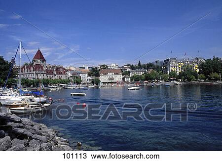 Boats at port with hotel in background, Lake Geneva, Chateau D'Ouchy, Lausanne, Vaud, Italy View Large Photo Image Stock Image - Boats at port with hotel in background, Lake Geneva, Chateau D'Ouchy, Lausanne, Vaud, Italy . Fotosearch