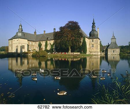 Stock Image - Castle along pond, Wettringen, North Rhine-Westphalia, Germany, Europe . Fotosearch