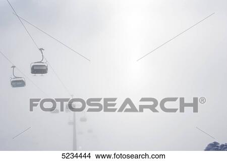 Picture - Chairlift in the fog, Arlberg . Fotosearch