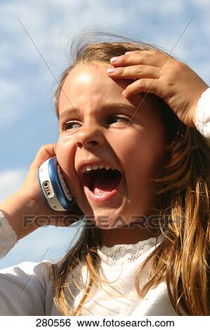 Stock Photograph - Close-up of girl shouting on mobile phone . Fotosearch
