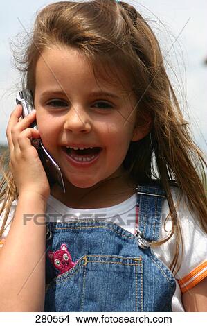 Close-up of girl talking on mobile phone View Large Photo Image Picture - Close-up of girl talking on mobile phone . Fotosearch