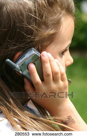 Close-up of girl using mobile phone View Large Photo Image Stock Image - Close-up of girl using mobile phone . Fotosearch