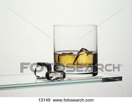 Close-up of ice cubes in glass of whiskey View Large Photo Image Stock Photo - Close-up of ice cubes in glass of whiskey . Fotosearch