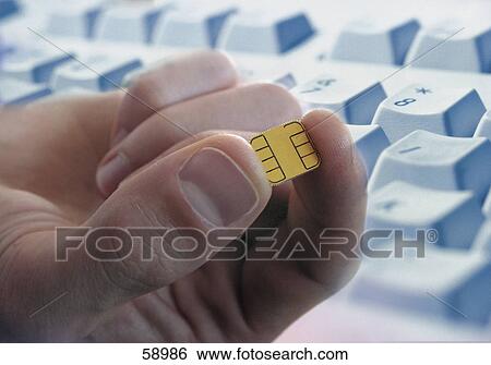 Close-up of person holding computer chip View Large Photo Image Stock Photograph - Close-up of person holding computer chip . Fotosearch