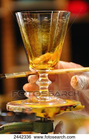 Stock Photograph - Close-up of person holding painted glass . Fotosearch