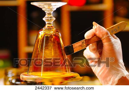 Stock Photo - Close-up of person painting glass . Fotosearch