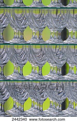 Stock Image - Close-up of wineglasses in shelves . Fotosearch