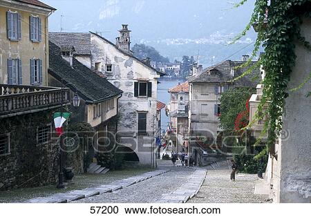 Stock Image - Cobblestoned stepped pavement in village with lake in background, Lake Orta, San Giulio, Piedmont, Italy . Fotosearch