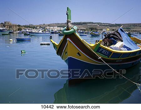 Stock Image - Colored boats at harbor, Marsaxlokk, Malta . Fotosearch