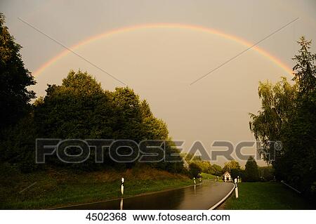Country road and rainbow View Large Photo Image Stock Photo - Country road and rainbow . Fotosearch