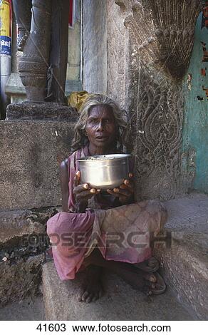 Female beggar sitting at entrance of temple, Rockfort Ucchi Pillayar Temple, Tiruchirapalli, Tamil Nadu, India View Large Photo Image Stock Image - Female beggar sitting at entrance of temple, Rockfort Ucchi Pillayar Temple, Tiruchirapalli, Tamil Nadu, India . Fotosearch