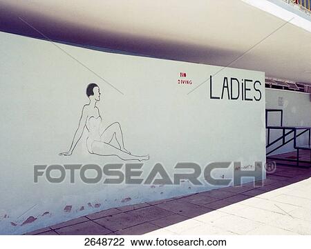 Stock Image - Female figure on wall of changing room at swimming pool, Cape Town, South Africa . Fotosearch