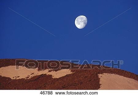 Stock Photo - Full moon over mountain, Grand Canyon, Arizona, USA . Fotosearch