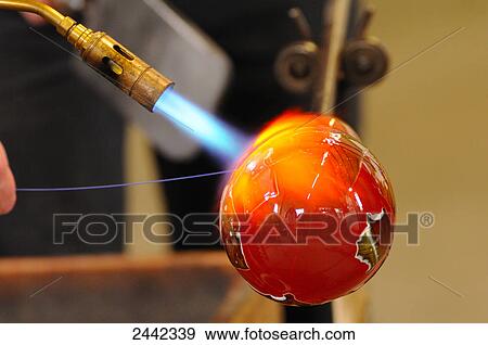Stock Photo - Glassblower making drinking glass . Fotosearch