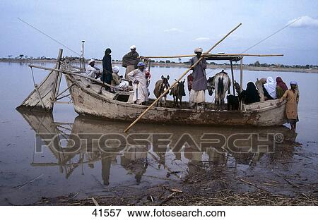 Stock Photo - Group of people in boat, Pakistan . Fotosearch