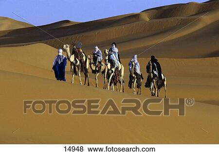 Group of people riding camel in desert View Large Photo Image Stock Photo - Group of people riding camel in desert . Fotosearch
