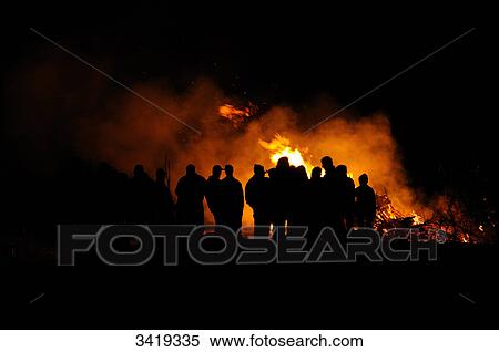 Stock Photography - Group of people standing around a fire, Bavaria, Germany . Fotosearch