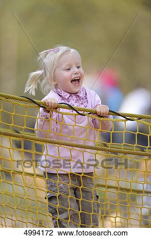 Happy girl on the playground View Large Photo Image Stock Image - Happy girl on the playground . Fotosearch
