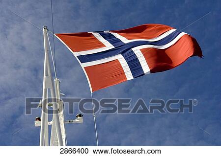 Stock Image - Low angle view of Norwegian flag fluttering, Norway . Fotosearch